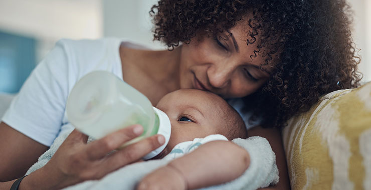Mother feeding baby a bottle
