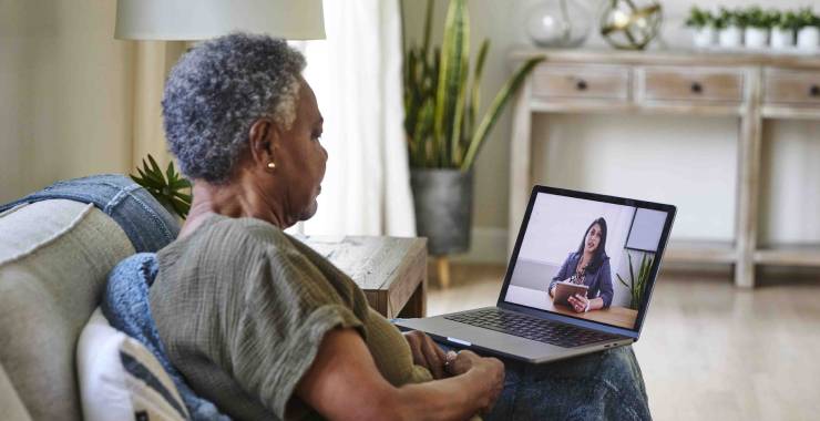 Senior woman consulting with a psychologist on a video call