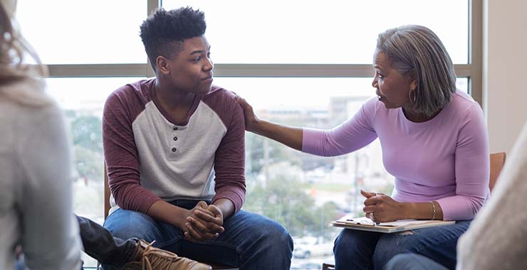 Black teen male in group therapy
