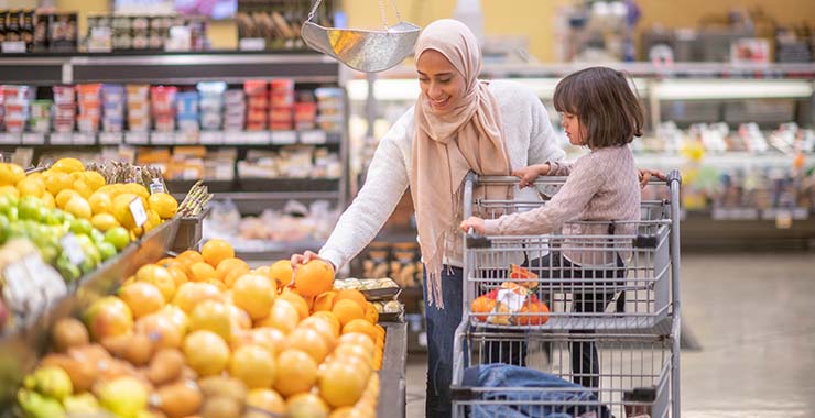 Middle Eastern mother and daughter grocery shopping