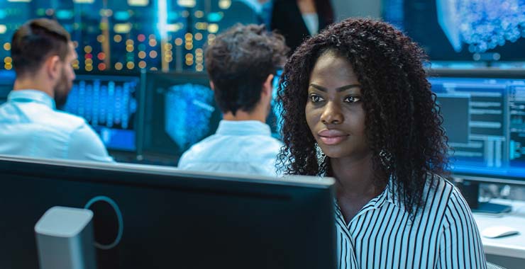 People at computers in a tech room