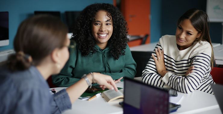 A group of coworkers happily socializing in the office