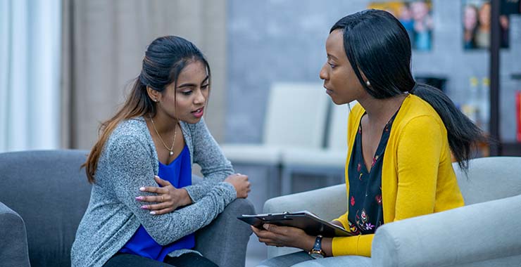 Health and wellness coordinator meeting with an Asian Pacific American woman