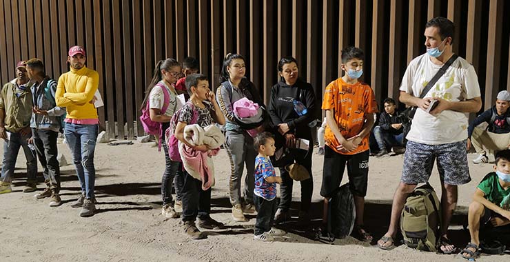 A group of immigrants standing outside