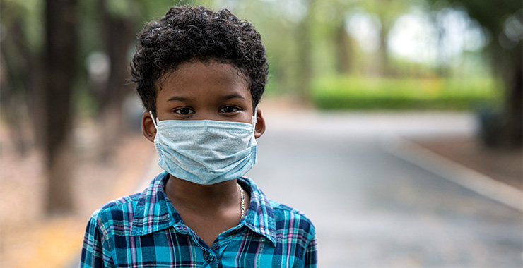 Young boy wearing a medical face mask