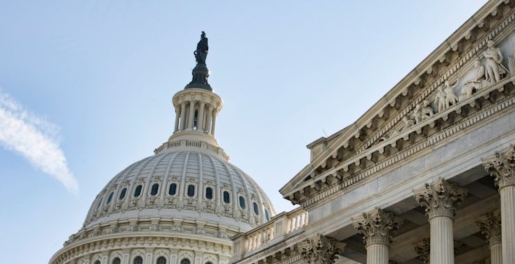 Close-up of the dome of the Washington Capitol Building against a backdrop of a clear blue sky