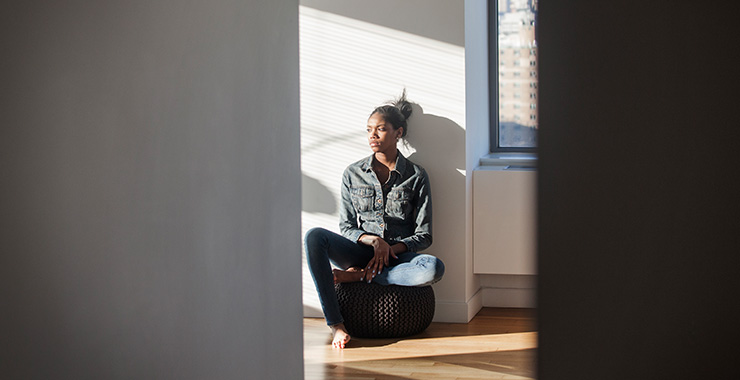 Young woman sitting thoughtfully