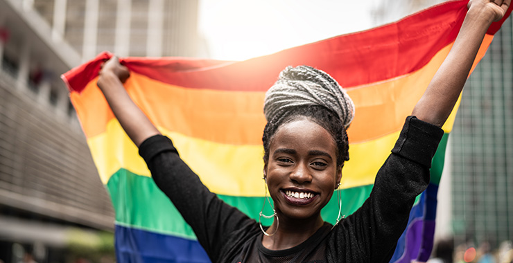 Woman holding LGBTQ pride flag