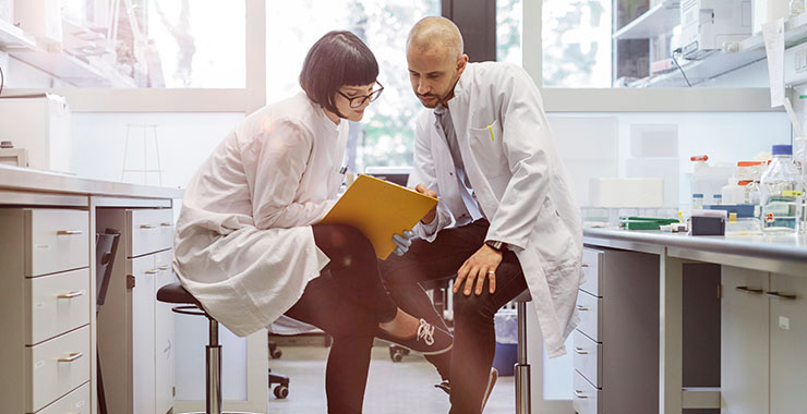 Scientist in a lab looking at a file