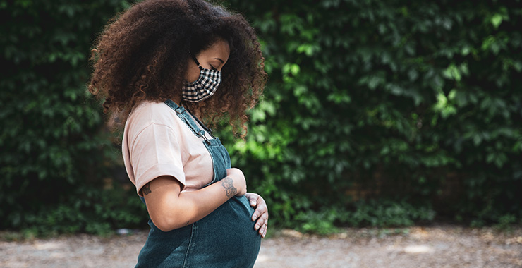 Pregnant woman wearing a face mask