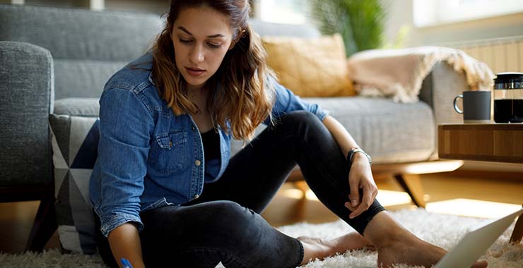 Woman looking at student loan bill