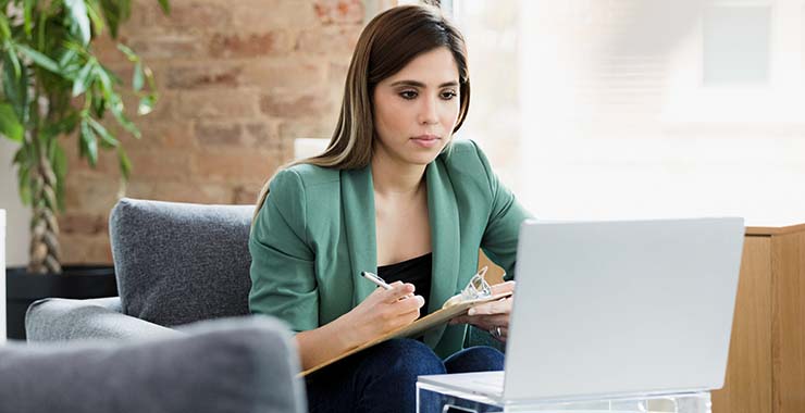Psychologist taking notes on a video call