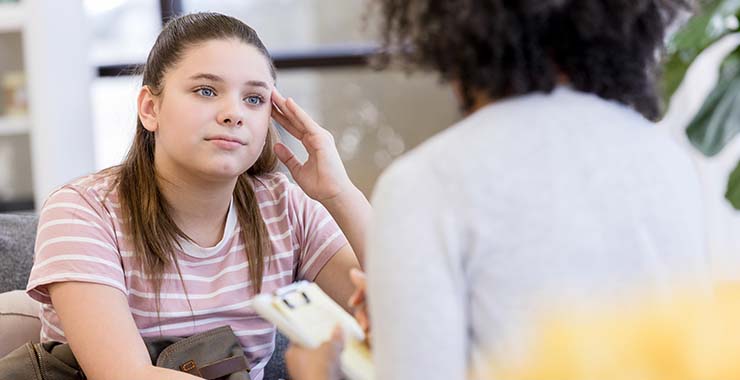 Teen girl meeting with a psychologist