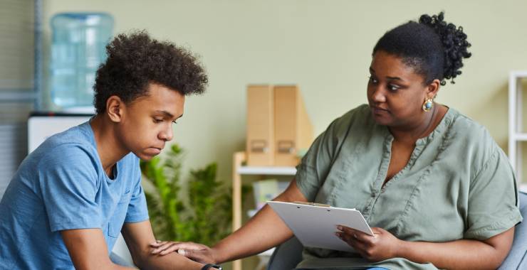 Child psychologist engaging with an adolescent boy