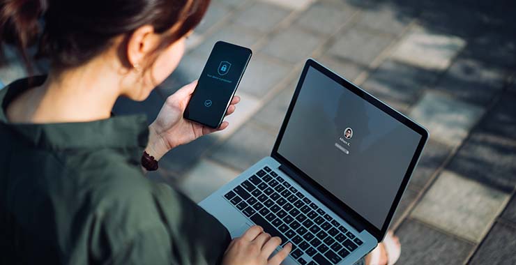 Woman using laptop and smartphone