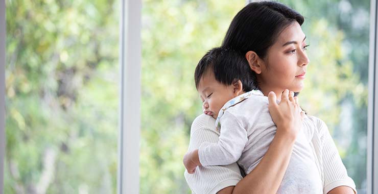 Mother holding her infant child
