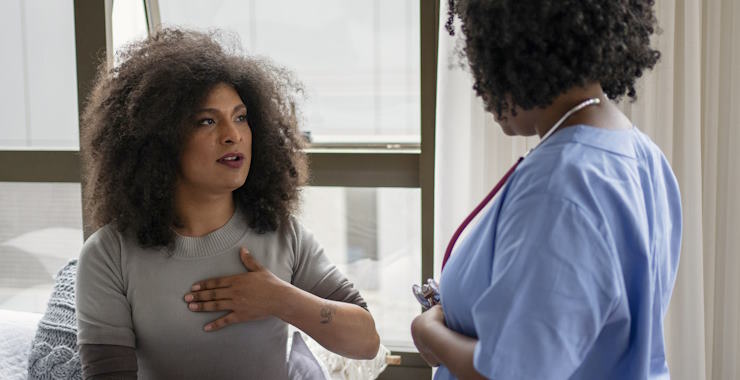 A transgender patient talking to a doctor in an office