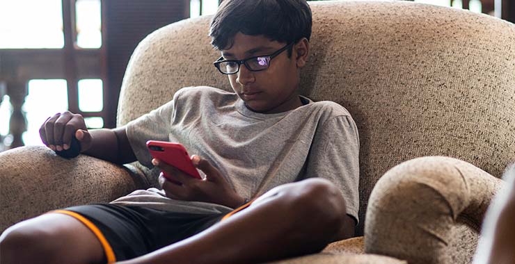 Boy looking at his cell phone
