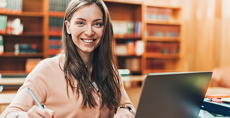 Woman smiling and using her laptop