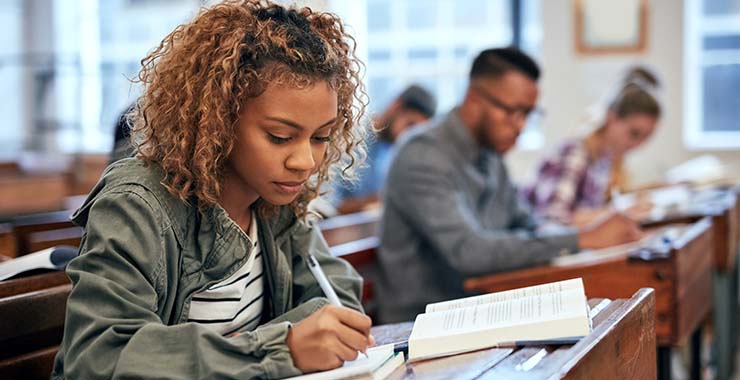 Students in a classroom taking notes