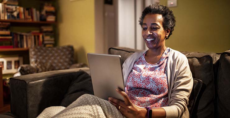 Woman using tablet computer for telehealth appointment