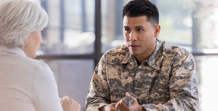 Military member speaking with someone