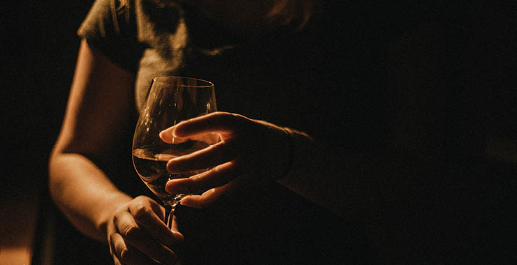 person holding glass of wine