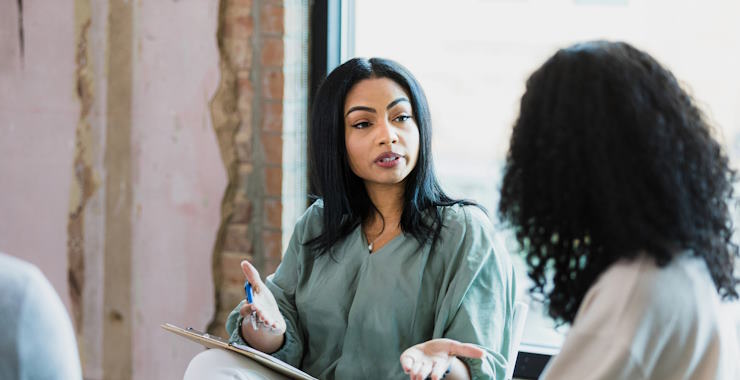 A woman is engaged in a conversation with a mental health expert