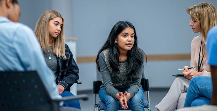 Teenagers and counselors in a group meeting
