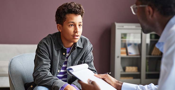 Youth male speaking with doctor