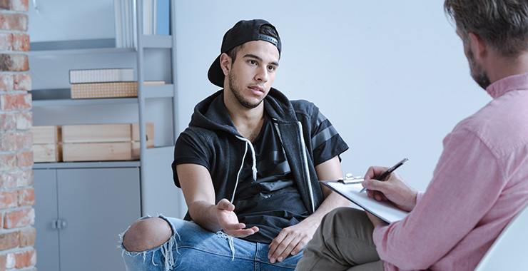 teen student talking with professional