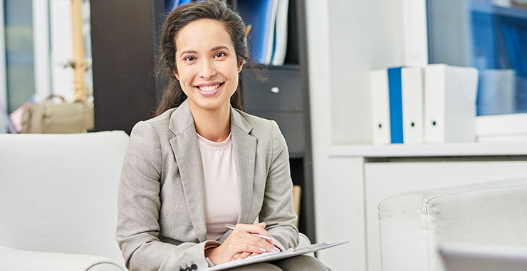 professional woman holding a pen and paper