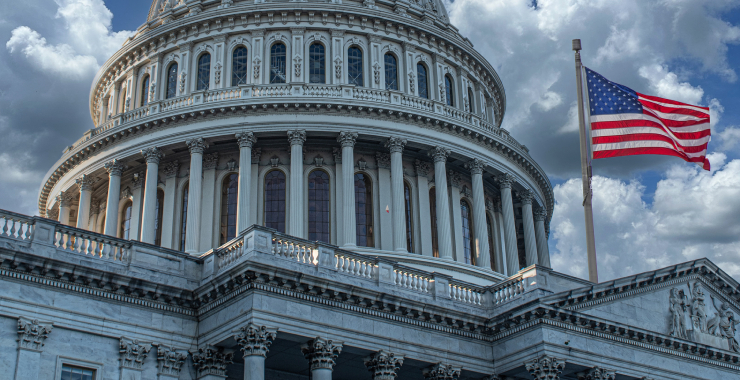 close-up of Capitol with American flag