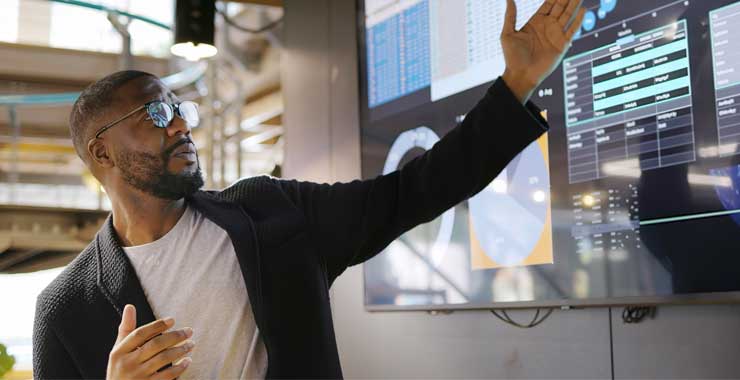 Man pointing to large computer screen