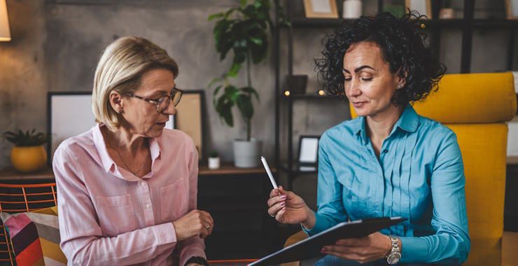 Two women work from home sign contract document or insurance policy