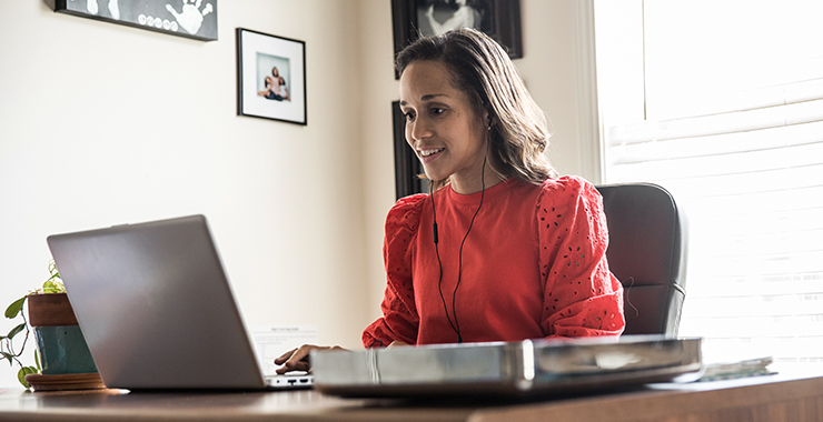 woman at laptop computer with ear buds