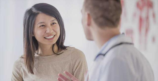 Young woman speaking with healthcare professional