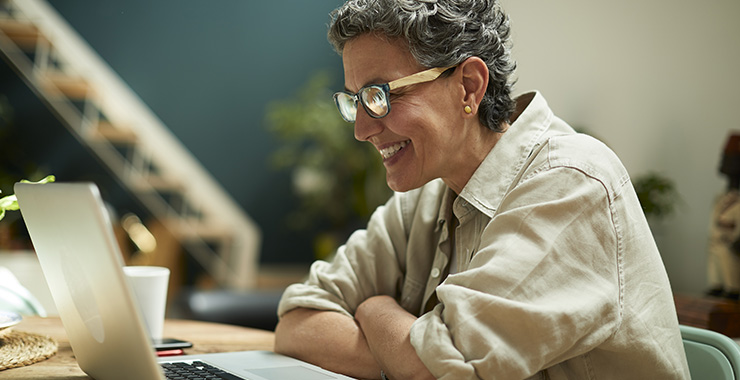 Smiling woman using a laptop