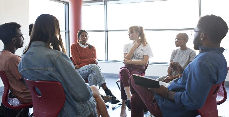 Sad woman sharing with friends and instructor