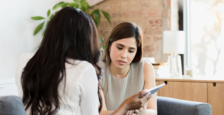 professional and client looking at a smart tablet