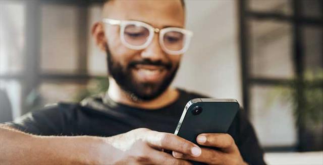 A man interacting with his phone.