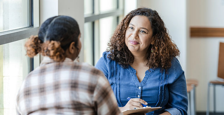 Young woman conversing with counselor