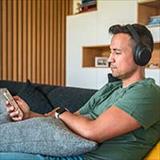 Man with headphones looking at his phone