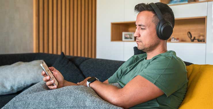 Man with headphones looking at his phone