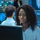 People at computers in a tech room