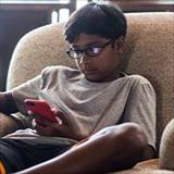 Boy looking at his cell phone