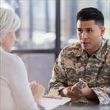 Military member speaking with someone